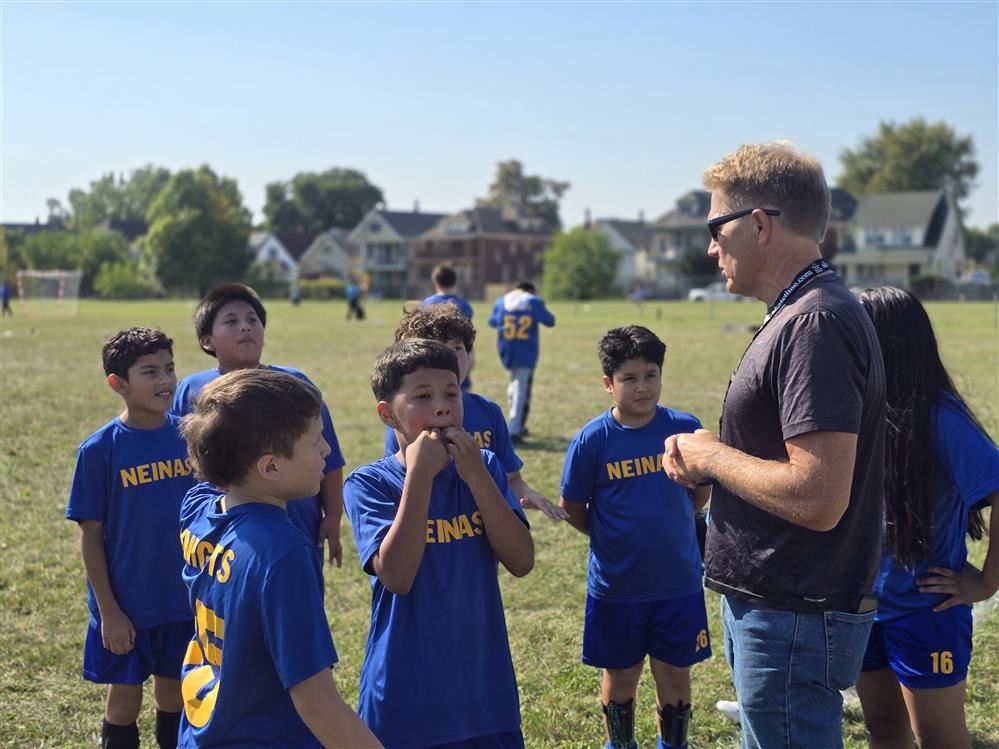student athletes with coach